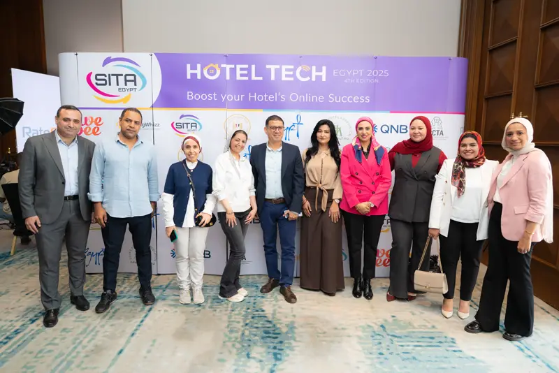 Team photo at the Hotel Tech 2025 backdrop